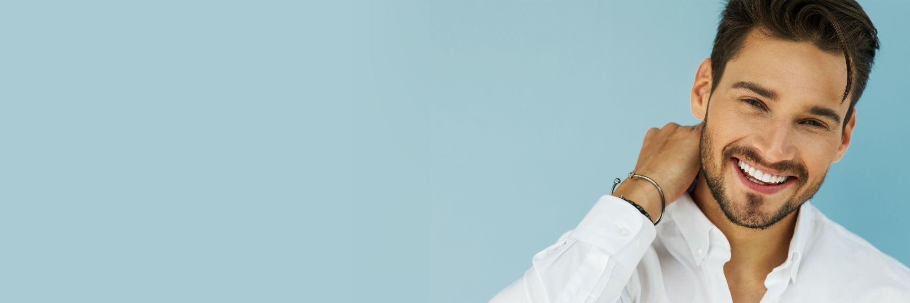 man with dental implants smiling in durham nc