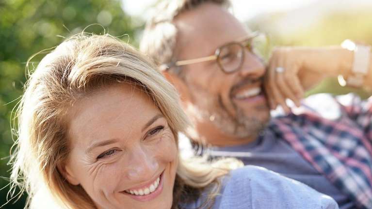 A couple smiling after a Dental Implants treatment in Durham