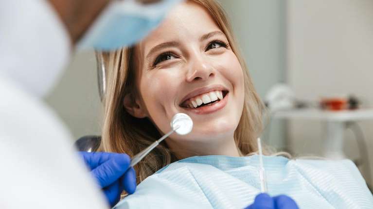 woman smiling during dental cleaning in durham