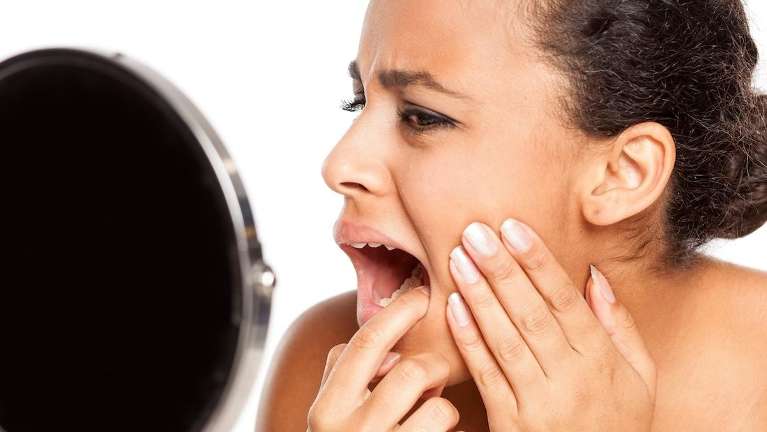 A woman checking his Root Canals in Durham, NC