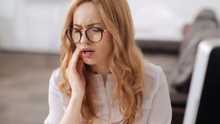 Lady Suffering Toothache