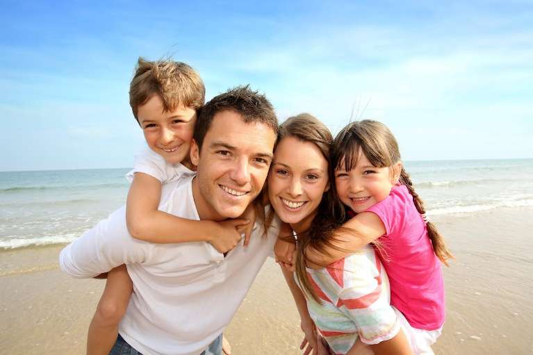 A Family Smiling Together after Dental check up in Durham, NC