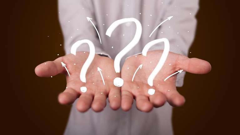 hands holding illustrated question marks