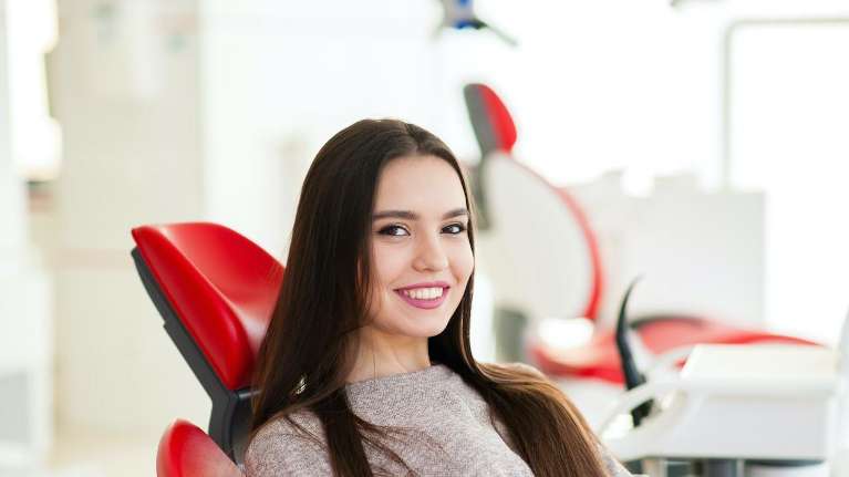 A woman smiling after undergoing a Tooth Extractions in Durham, NC